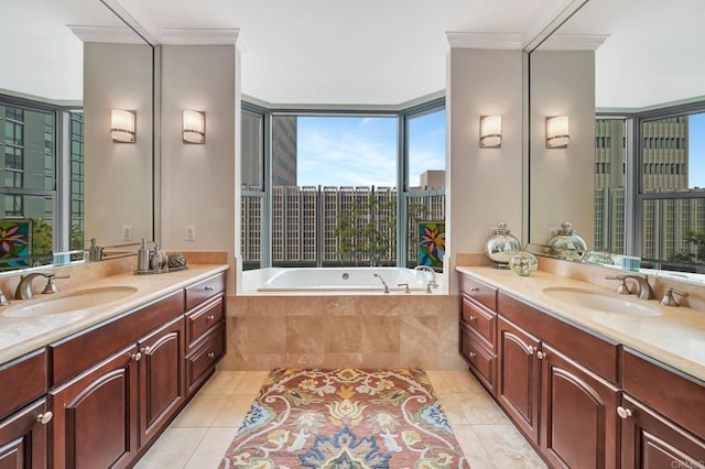 bathroom featuring ornamental molding, tile patterned floors, tiled tub, and vanity