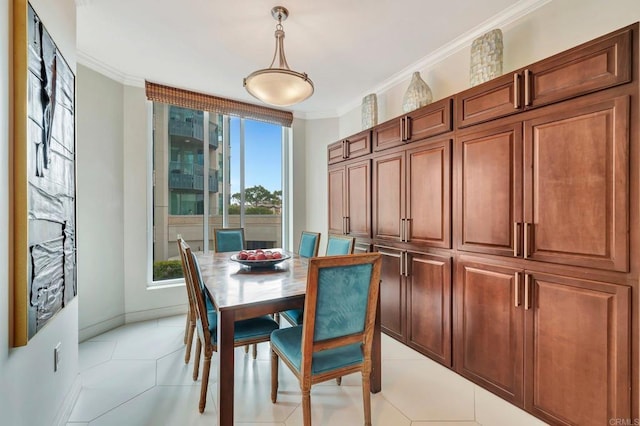 dining room with crown molding and light tile patterned flooring