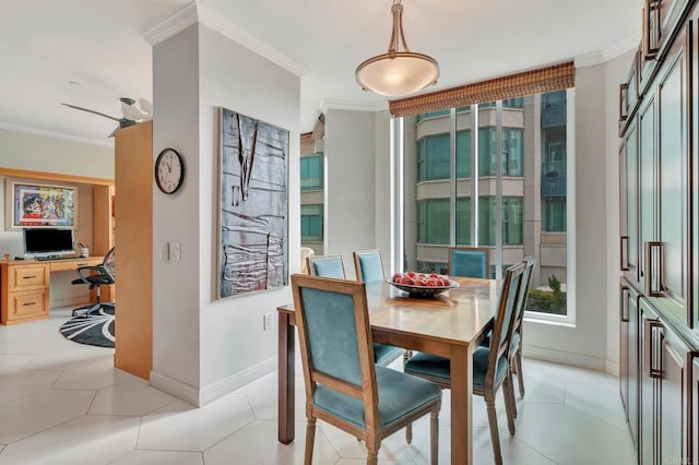 tiled dining space with ceiling fan and ornamental molding