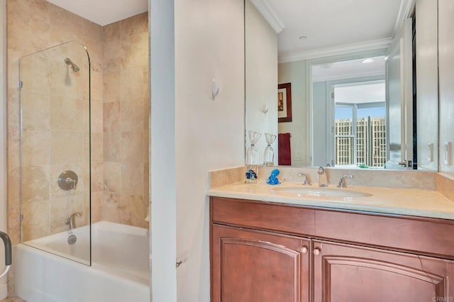 bathroom with vanity, crown molding, and tiled shower / bath