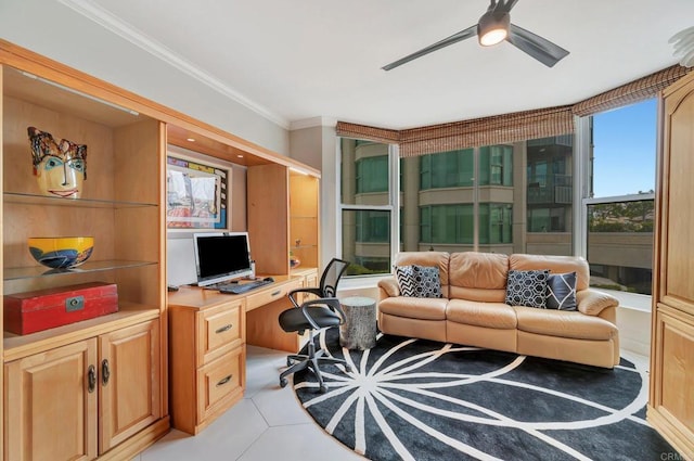 office area with ceiling fan, light tile patterned flooring, ornamental molding, and built in desk