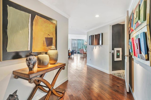 hallway featuring dark wood-type flooring and crown molding