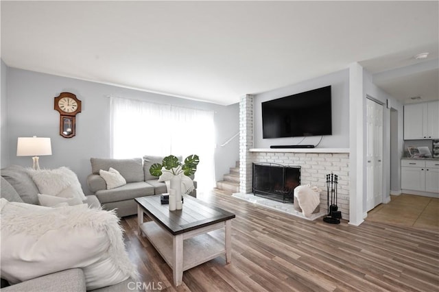 living room featuring hardwood / wood-style flooring and a fireplace