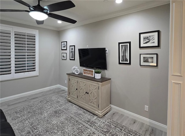 living room with ceiling fan, hardwood / wood-style floors, and ornamental molding