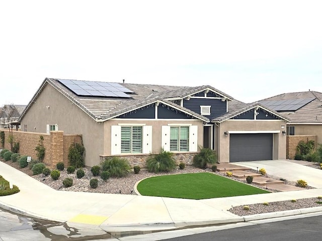 view of front of house with a garage and solar panels