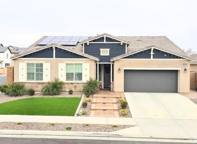 craftsman inspired home with a garage, a front lawn, and solar panels