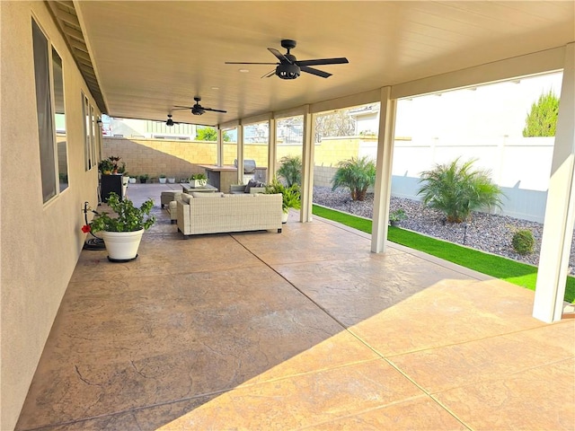 view of patio with ceiling fan and an outdoor living space