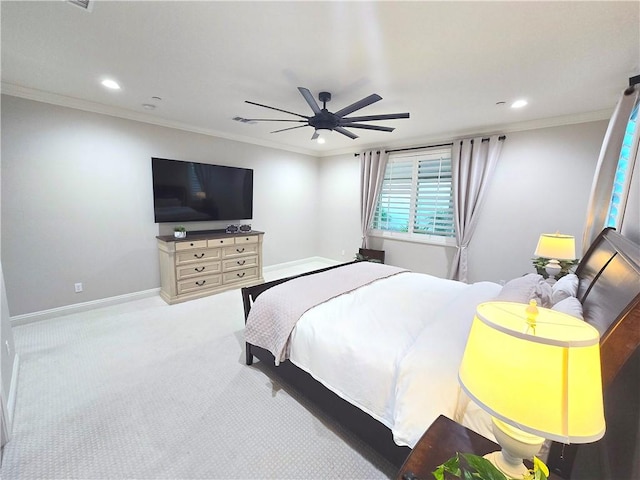 carpeted bedroom featuring ceiling fan and ornamental molding