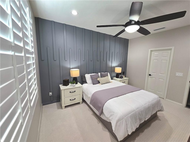 bedroom with ceiling fan and light carpet