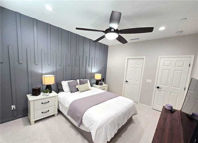 bedroom with ceiling fan and light carpet