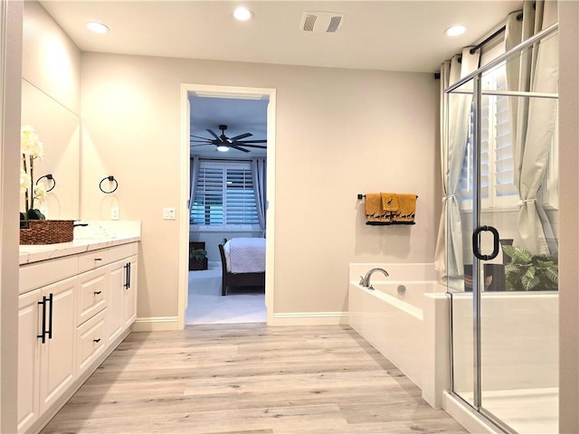 bathroom featuring ceiling fan, shower with separate bathtub, wood-type flooring, and vanity