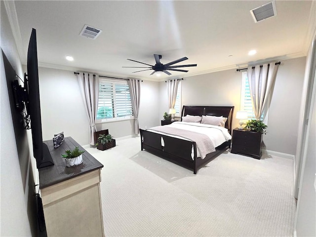 carpeted bedroom with ceiling fan and crown molding