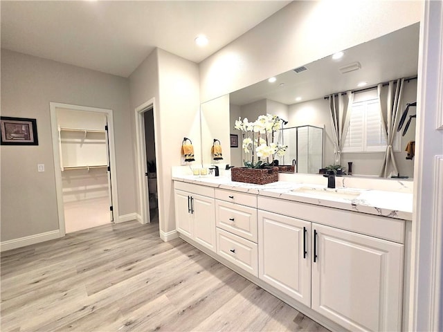 bathroom featuring vanity, toilet, hardwood / wood-style floors, and a shower with door