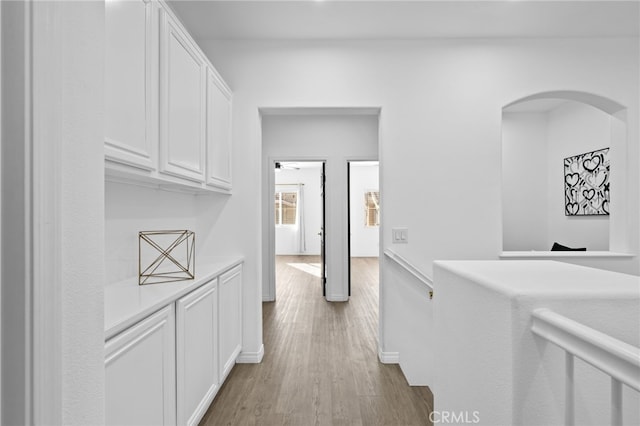 hallway with light hardwood / wood-style floors