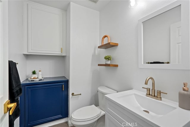 bathroom featuring toilet and vanity