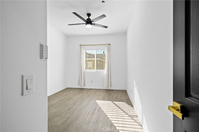 spare room featuring ceiling fan and light wood-type flooring