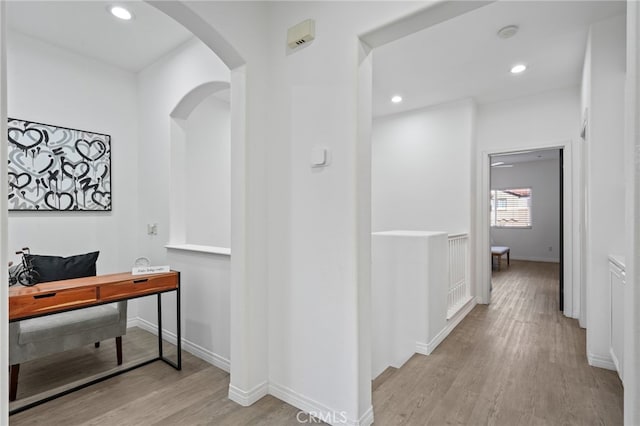 hallway with light hardwood / wood-style flooring