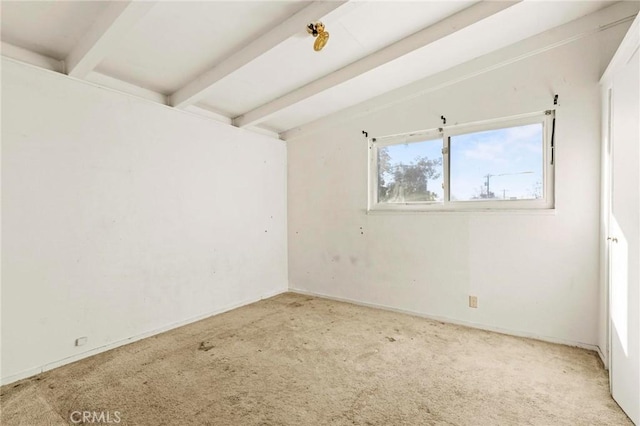 carpeted empty room with vaulted ceiling with beams