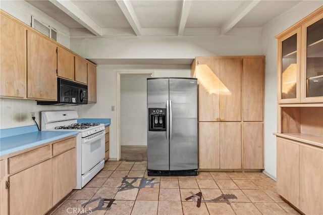 kitchen with gas range gas stove, light countertops, black microwave, stainless steel refrigerator with ice dispenser, and beam ceiling