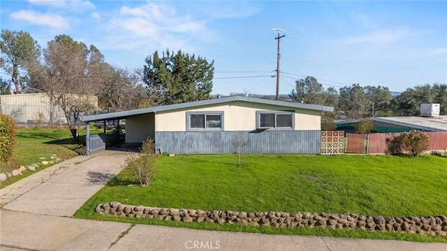 mid-century inspired home with a carport, driveway, a front lawn, and fence