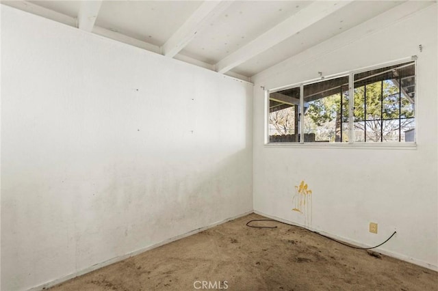 spare room with beam ceiling