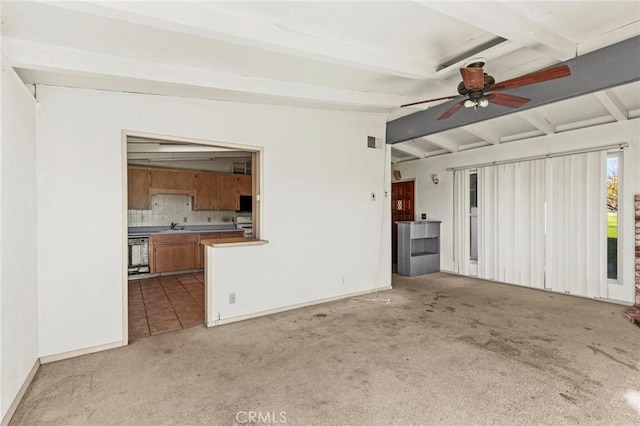 unfurnished living room featuring light carpet, visible vents, a ceiling fan, lofted ceiling with beams, and a sink