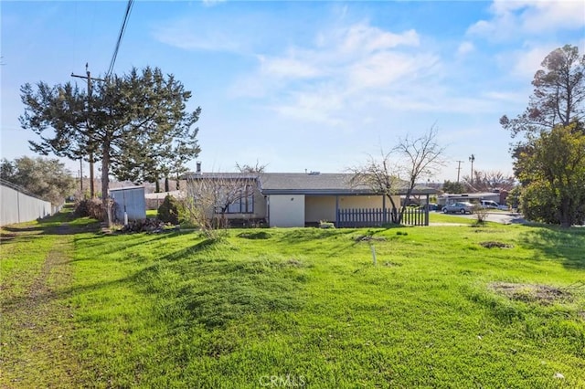 view of yard with an attached garage and fence