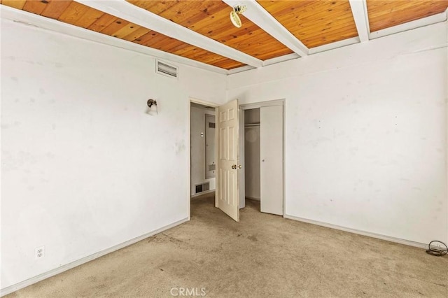 unfurnished bedroom with visible vents, wooden ceiling, beam ceiling, and light colored carpet