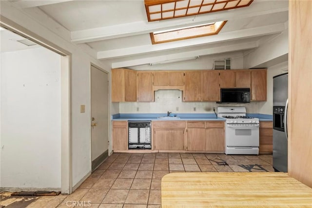 kitchen with dishwasher, white gas range, black microwave, stainless steel refrigerator with ice dispenser, and a sink