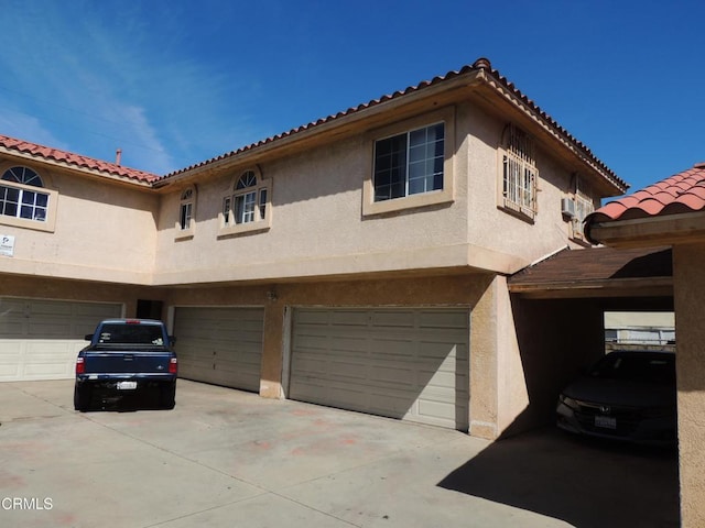 mediterranean / spanish-style home featuring a garage