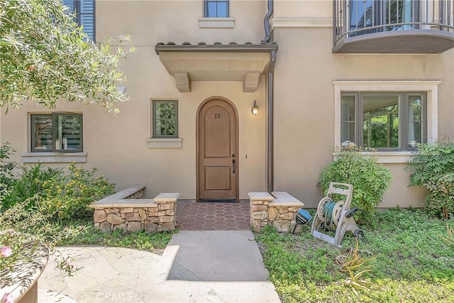 property entrance with stucco siding