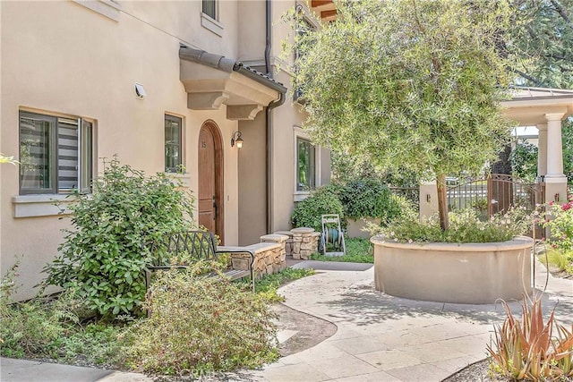 doorway to property with a patio area and stucco siding