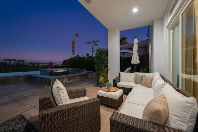 patio terrace at dusk featuring an outdoor hangout area