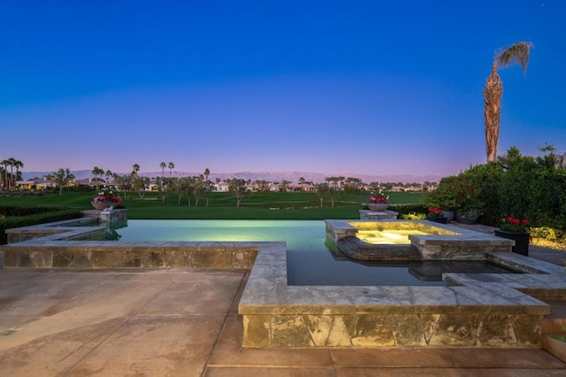 view of pool at dusk