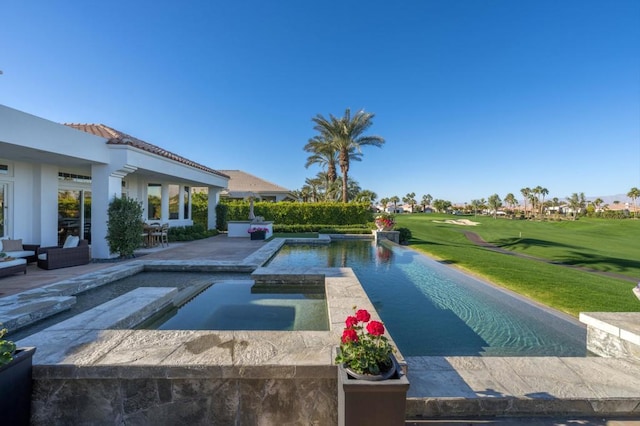 view of pool with a lawn and an in ground hot tub