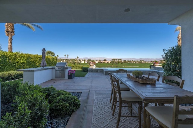 view of patio / terrace with an outdoor kitchen and a mountain view