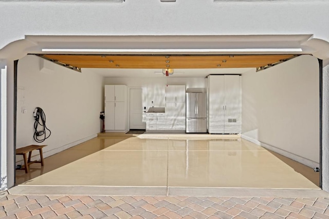 garage featuring stainless steel refrigerator