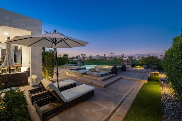 view of patio terrace at dusk