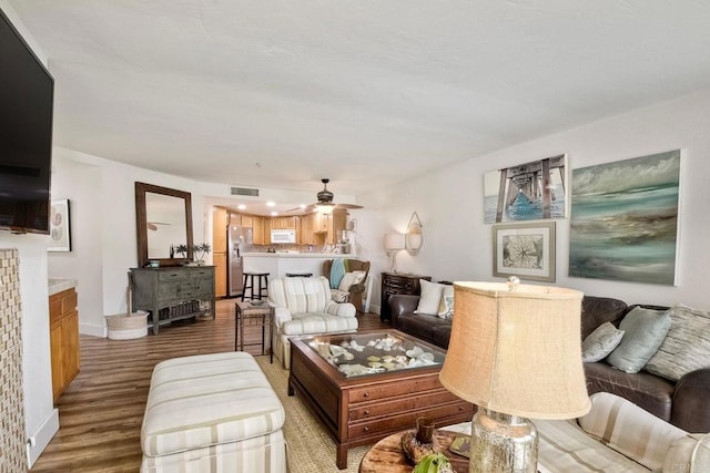 living room featuring hardwood / wood-style flooring and ceiling fan