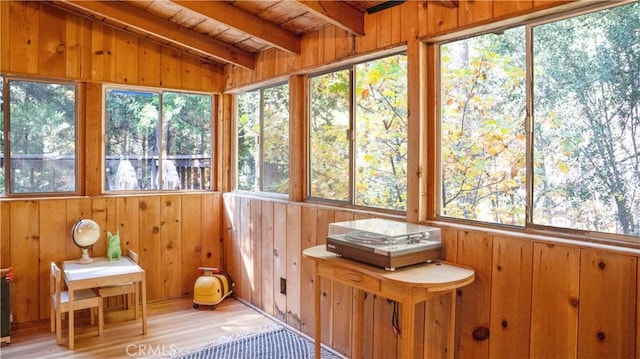 unfurnished sunroom featuring lofted ceiling with beams and wood ceiling