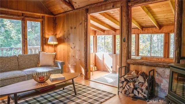 sunroom featuring vaulted ceiling with beams and wooden ceiling