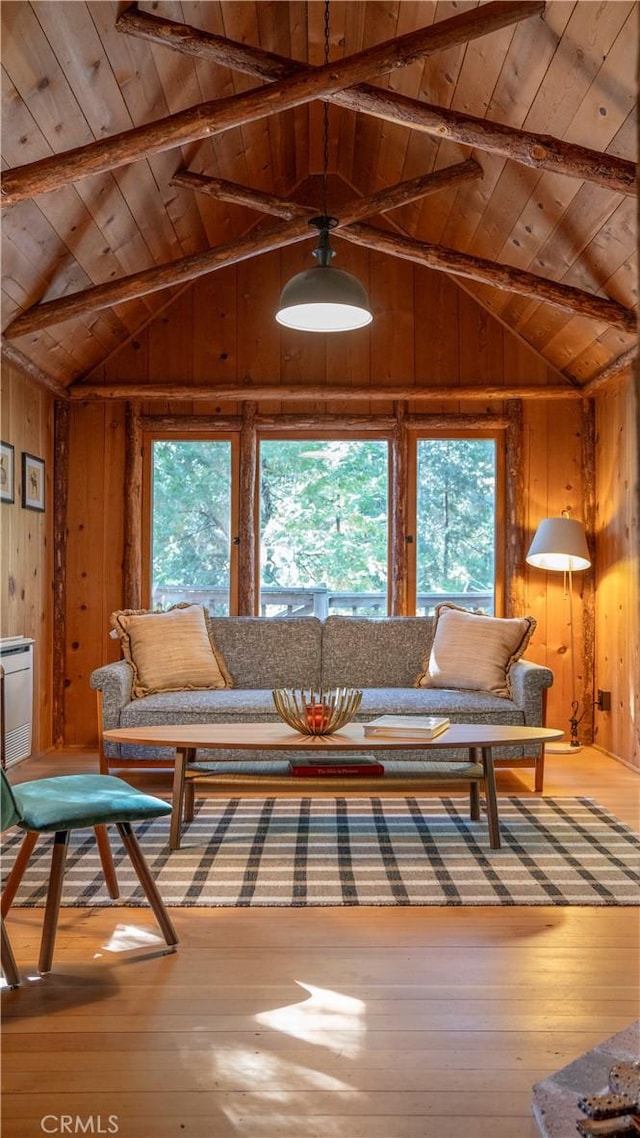 living room featuring wood ceiling, a healthy amount of sunlight, wooden walls, hardwood / wood-style flooring, and beam ceiling