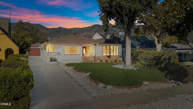 view of front facade with a mountain view and a yard