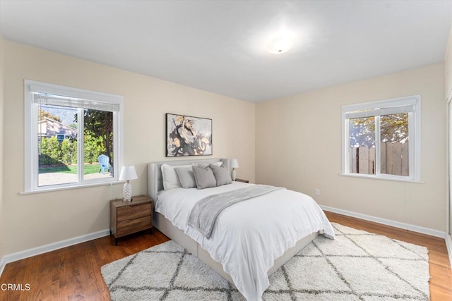 bedroom featuring wood-type flooring and multiple windows