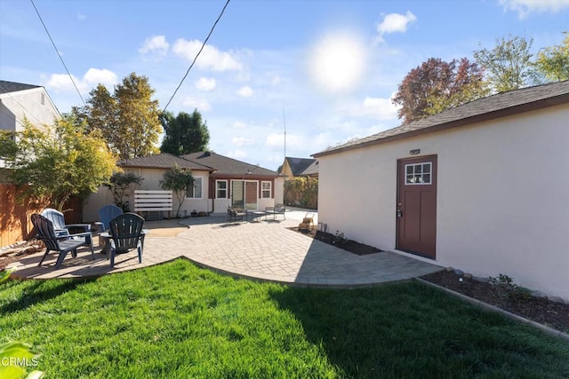 rear view of house featuring a patio area and a yard