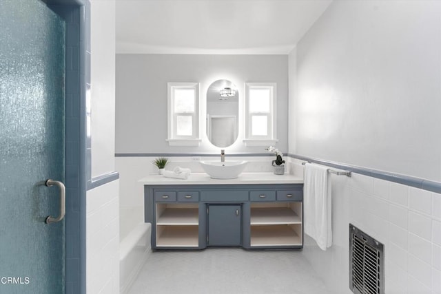 bathroom featuring heating unit, a shower with door, concrete flooring, and vanity