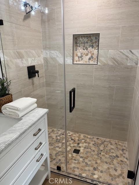 bathroom with hardwood / wood-style floors and walk in shower