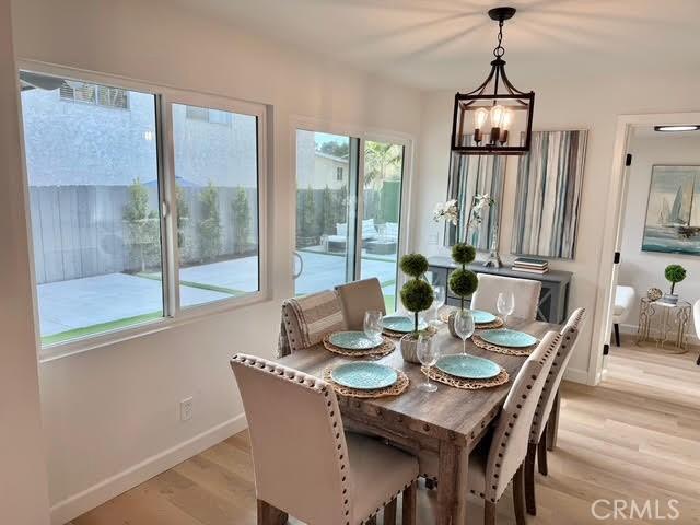 dining area with a notable chandelier and light wood-type flooring