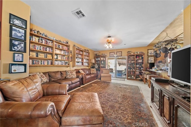 carpeted living room with ceiling fan