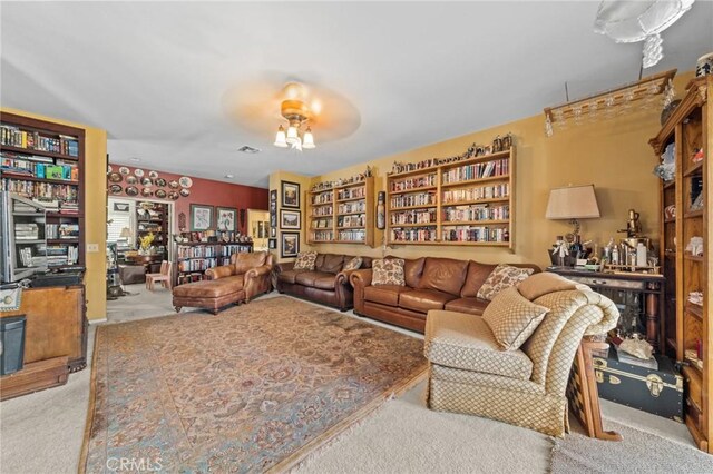 carpeted living room featuring ceiling fan